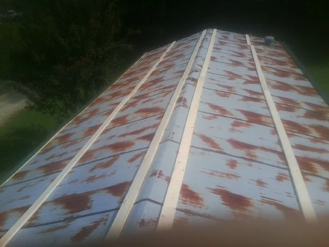Rusted metal roof panels with new wood purlins before replacement — Storm Damage Roof Repair in Aylett by Roofing Brothers